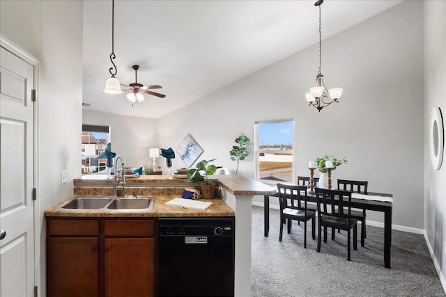 kitchen featuring pendant lighting, sink, dishwasher, vaulted ceiling, and light colored carpet