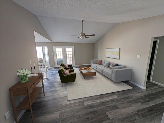 living room featuring dark wood-type flooring, lofted ceiling, and a textured ceiling