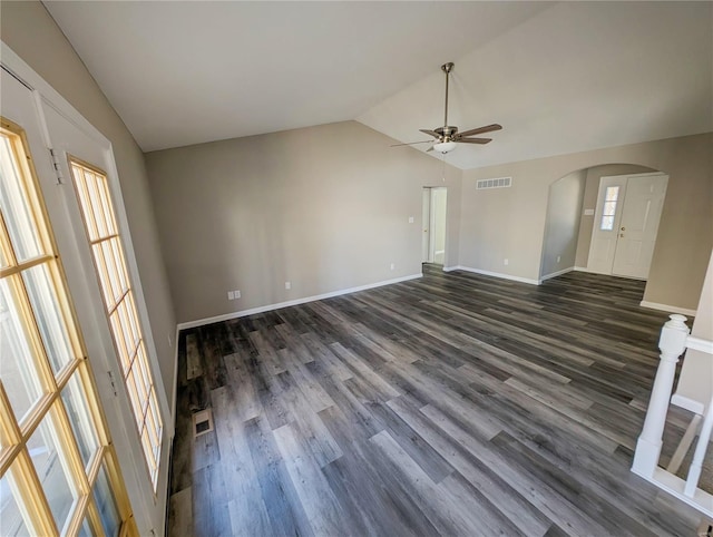 unfurnished living room featuring lofted ceiling, dark hardwood / wood-style floors, and ceiling fan