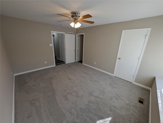 unfurnished bedroom featuring ceiling fan and carpet floors