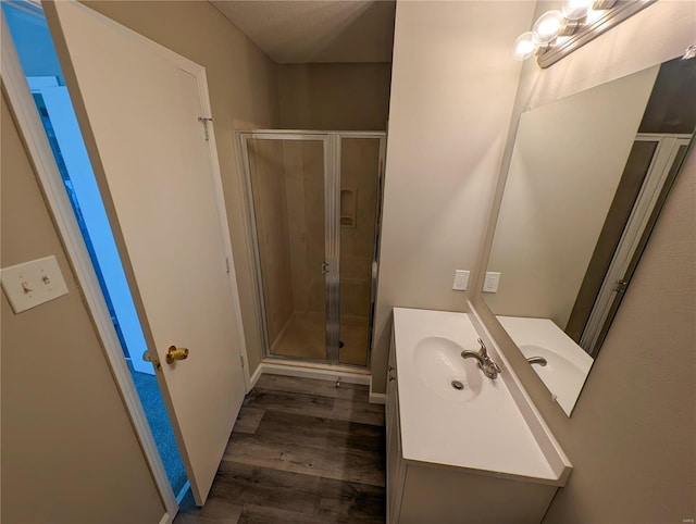 bathroom featuring vanity, hardwood / wood-style floors, and an enclosed shower