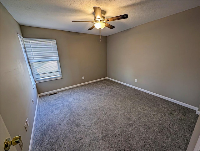 carpeted empty room featuring ceiling fan and a textured ceiling