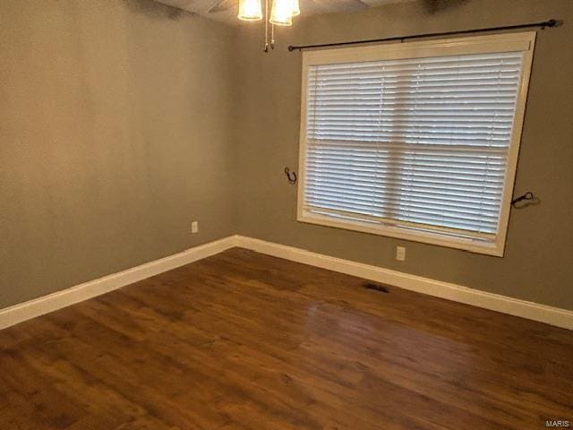 spare room with dark hardwood / wood-style flooring