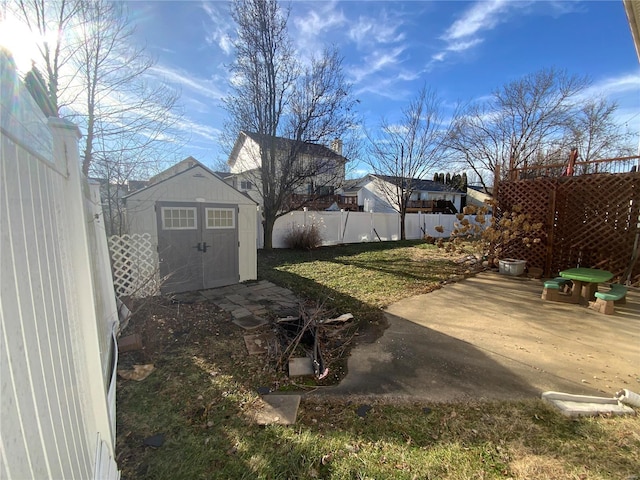 view of yard featuring a patio area and a storage shed