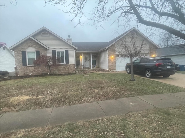 ranch-style home with a garage and a front yard