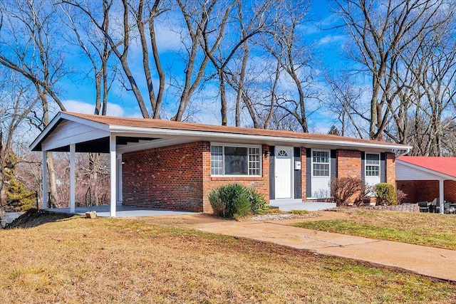 ranch-style home with a carport and a front lawn