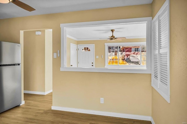 kitchen featuring ceiling fan, stainless steel fridge, and hardwood / wood-style floors