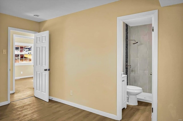 bedroom featuring hardwood / wood-style floors and ensuite bath