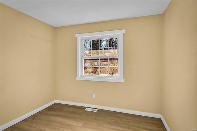 empty room with hardwood / wood-style flooring