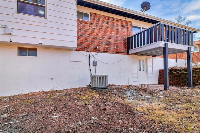 view of side of home with central air condition unit