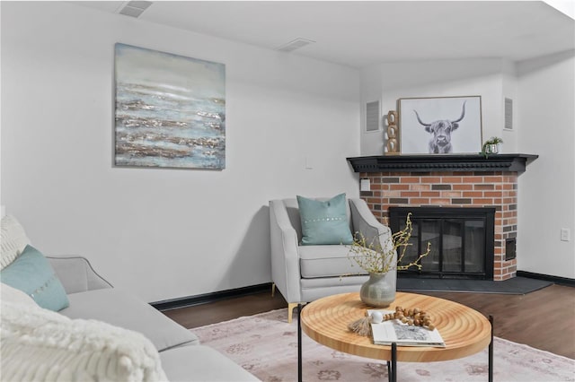 living room featuring a fireplace and dark hardwood / wood-style flooring