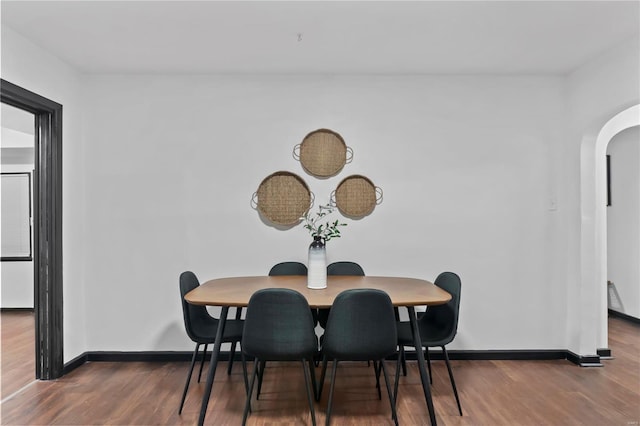 dining space with dark hardwood / wood-style flooring