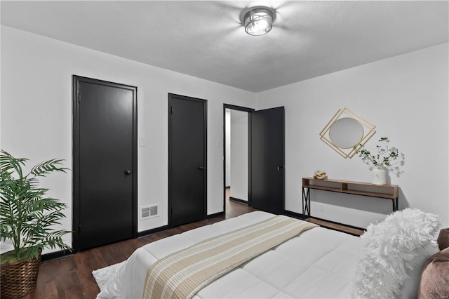 bedroom featuring dark wood-type flooring