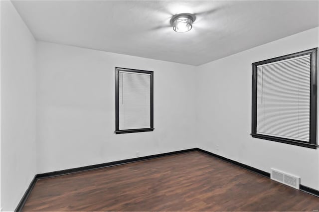 spare room featuring dark hardwood / wood-style flooring