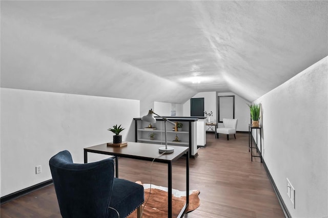 office featuring lofted ceiling, dark wood-type flooring, and a textured ceiling