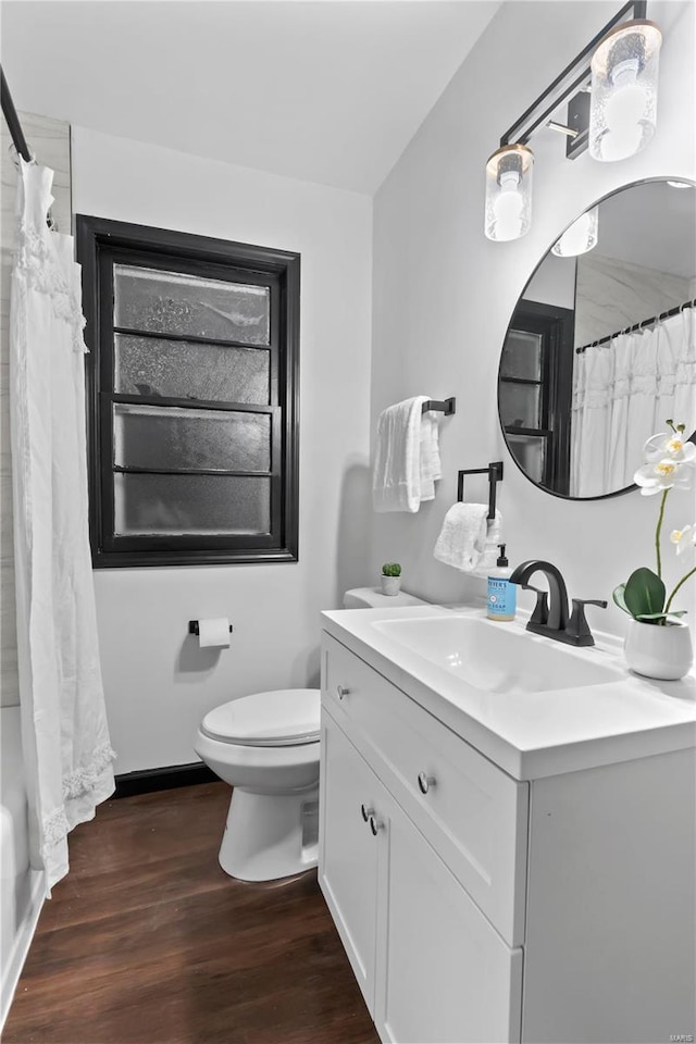 full bathroom featuring shower / bath combination with curtain, wood-type flooring, toilet, and vanity