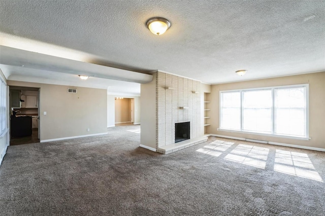 unfurnished living room featuring carpet, a brick fireplace, and a textured ceiling