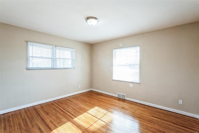 spare room with wood-type flooring