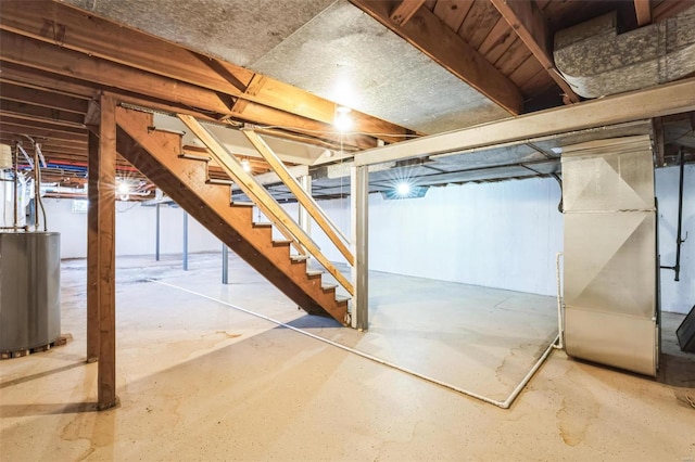 basement featuring gas water heater and heating unit