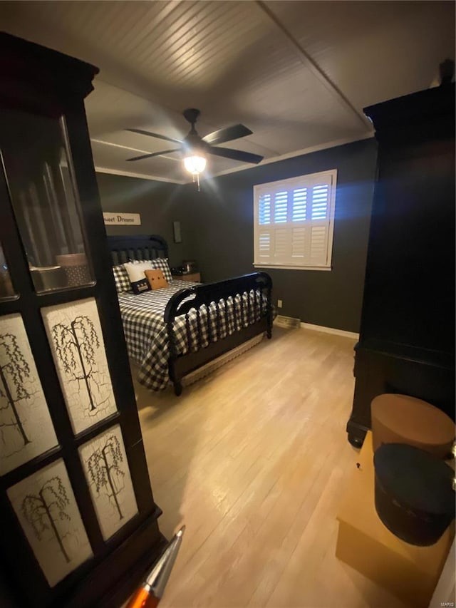 bedroom with ceiling fan and light hardwood / wood-style floors