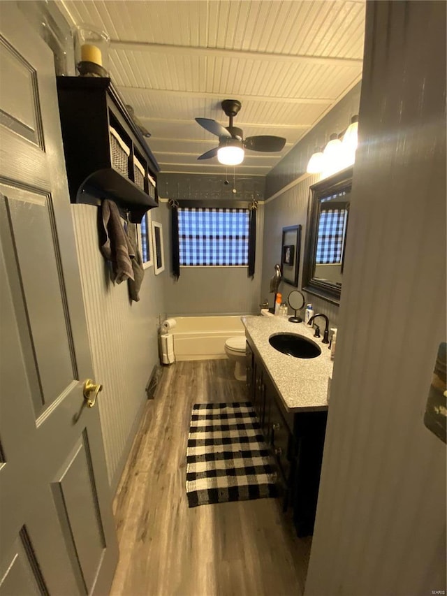 bathroom with hardwood / wood-style flooring, vanity, ceiling fan, wood ceiling, and toilet