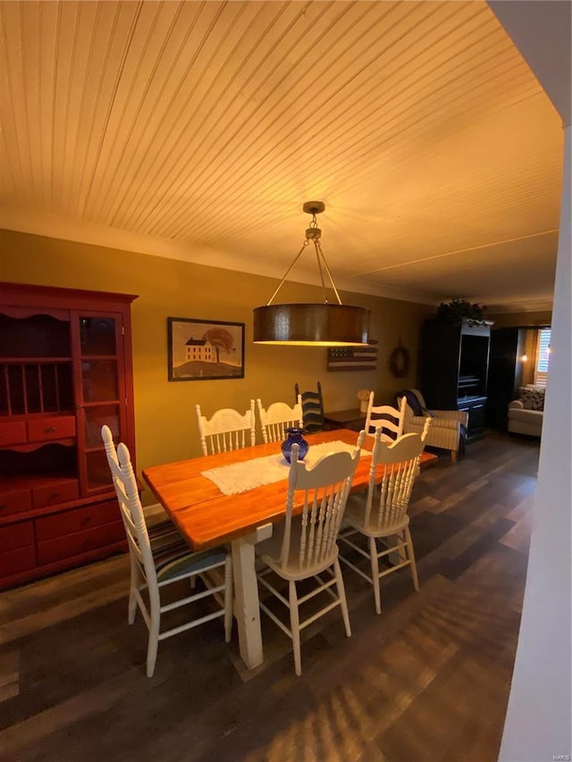 dining space featuring dark hardwood / wood-style floors and wooden ceiling