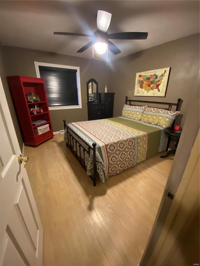 bedroom with hardwood / wood-style flooring and ceiling fan