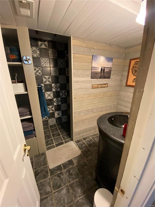 bathroom featuring vanity, wood ceiling, and wood walls