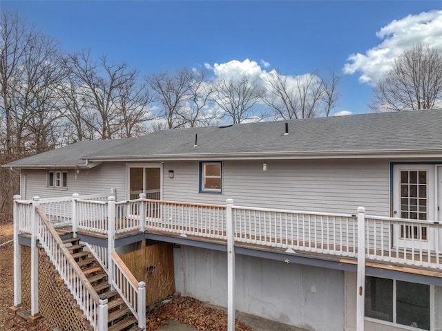 back of house with a deck