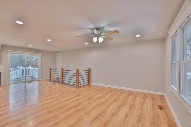 spare room featuring ceiling fan and light wood-type flooring