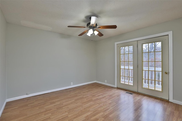 unfurnished room featuring ceiling fan, a textured ceiling, and light wood-type flooring