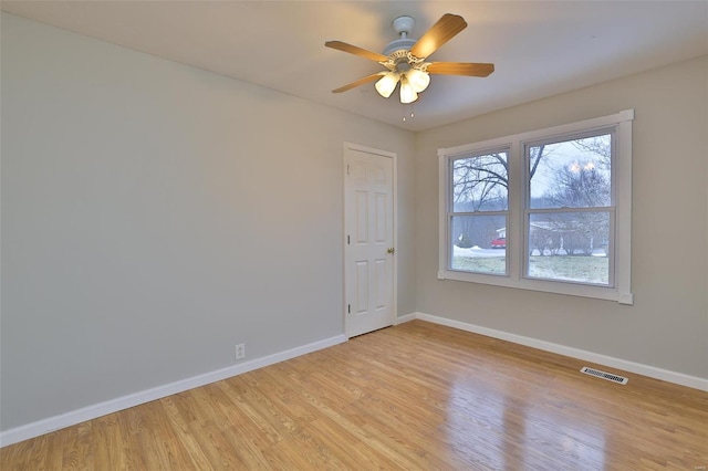 empty room with ceiling fan and light wood-type flooring