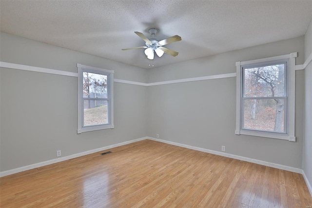 unfurnished room featuring ceiling fan, a textured ceiling, and light wood-type flooring