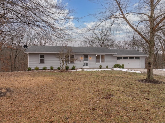 single story home featuring a garage and a front lawn