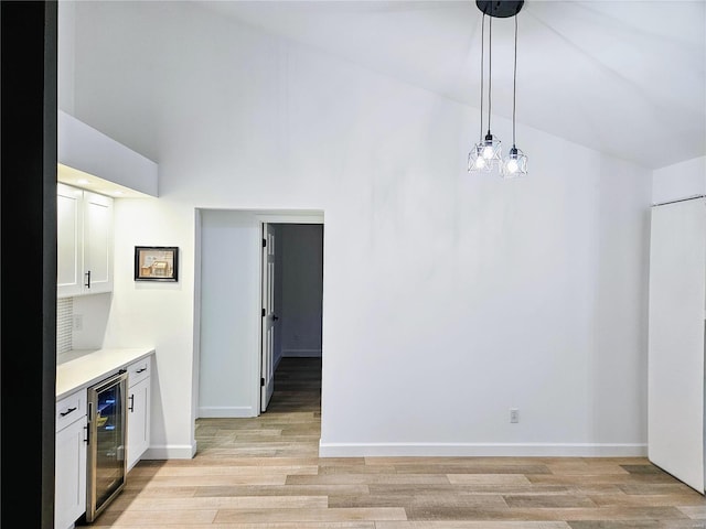 unfurnished dining area with light hardwood / wood-style flooring and beverage cooler