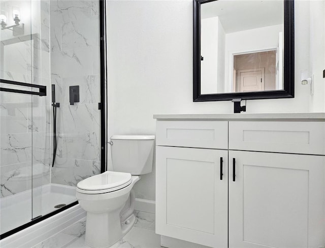 bathroom with vanity, a shower with shower door, and toilet