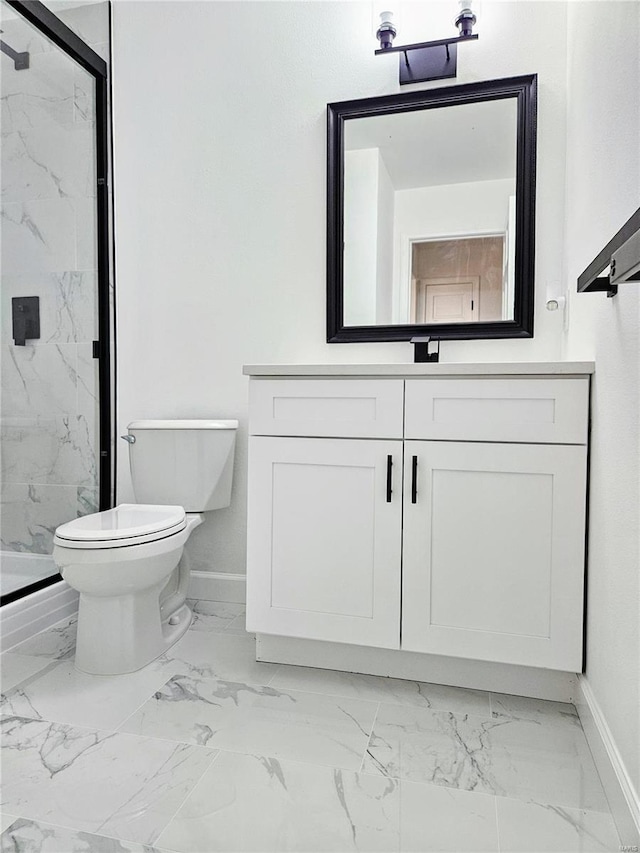 bathroom with vanity, toilet, and a shower with door