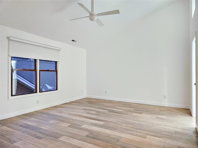 spare room with ceiling fan, high vaulted ceiling, and light hardwood / wood-style floors