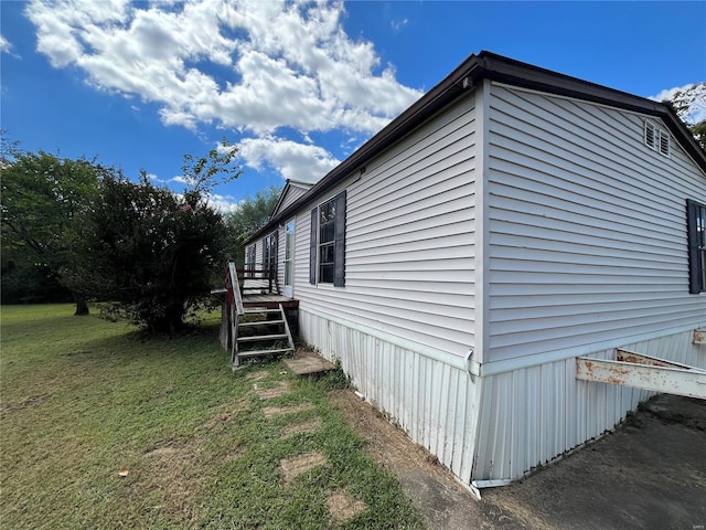 view of property exterior with a yard