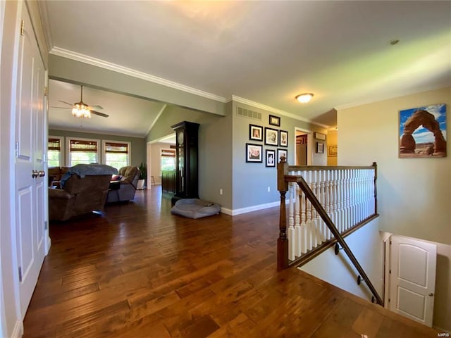 hallway featuring ornamental molding, dark hardwood / wood-style floors, and vaulted ceiling