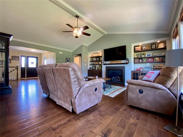 living room with built in features, ceiling fan, dark hardwood / wood-style floors, ornamental molding, and lofted ceiling with beams