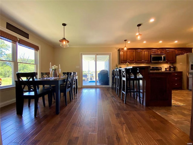 dining space with crown molding and dark hardwood / wood-style floors