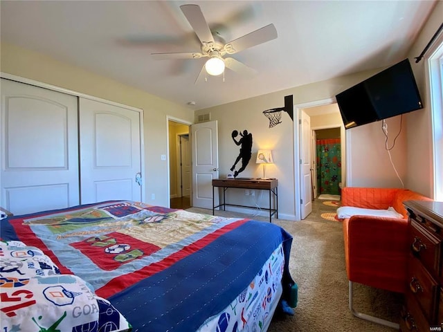 bedroom with light colored carpet, ceiling fan, and a closet