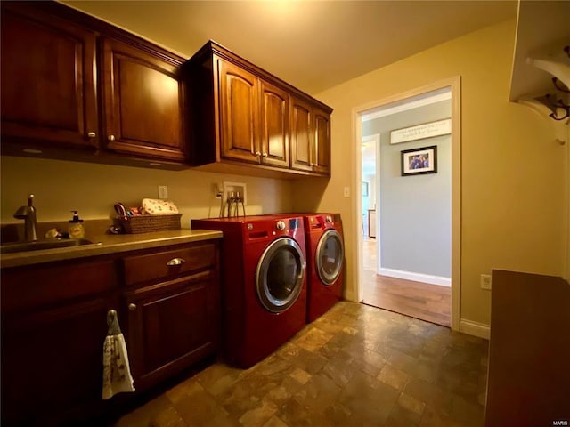 laundry area with cabinets, sink, and washing machine and clothes dryer