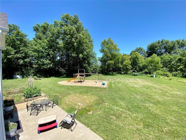 view of yard with a playground and a patio