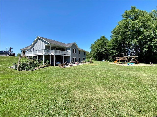 back of house with a lawn and a playground