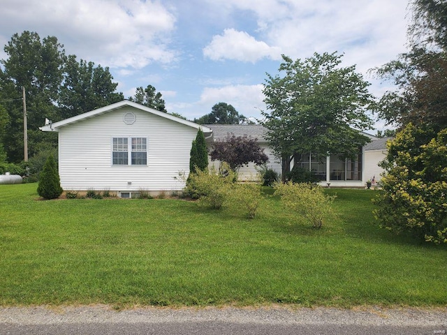 view of side of home featuring a lawn