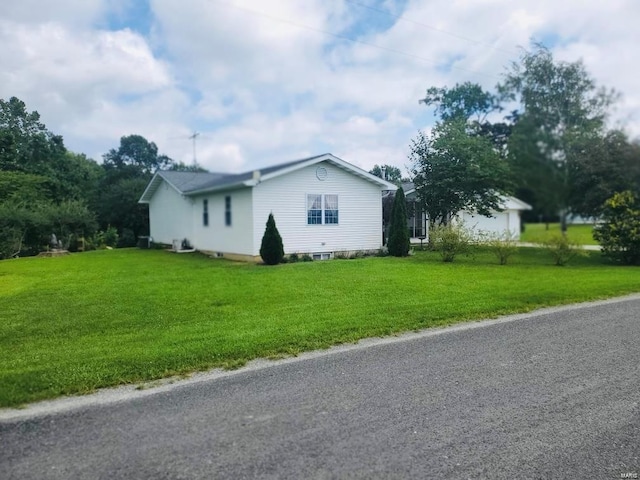 view of property exterior with a yard