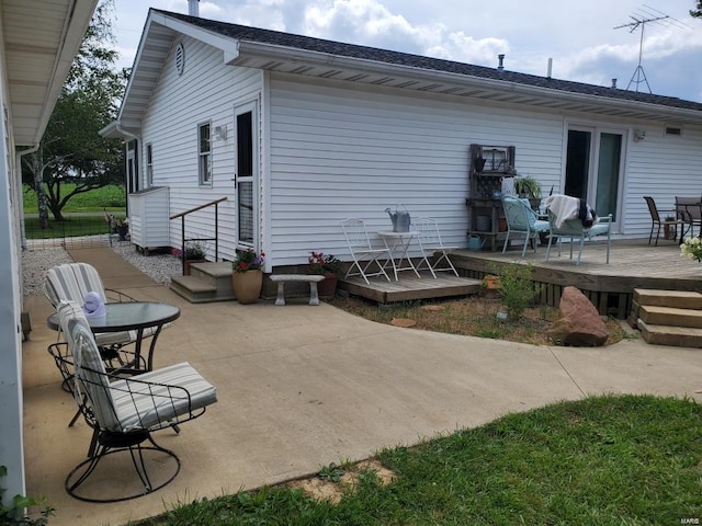 rear view of house featuring a patio and a deck