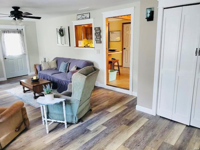 living room with hardwood / wood-style flooring and ceiling fan